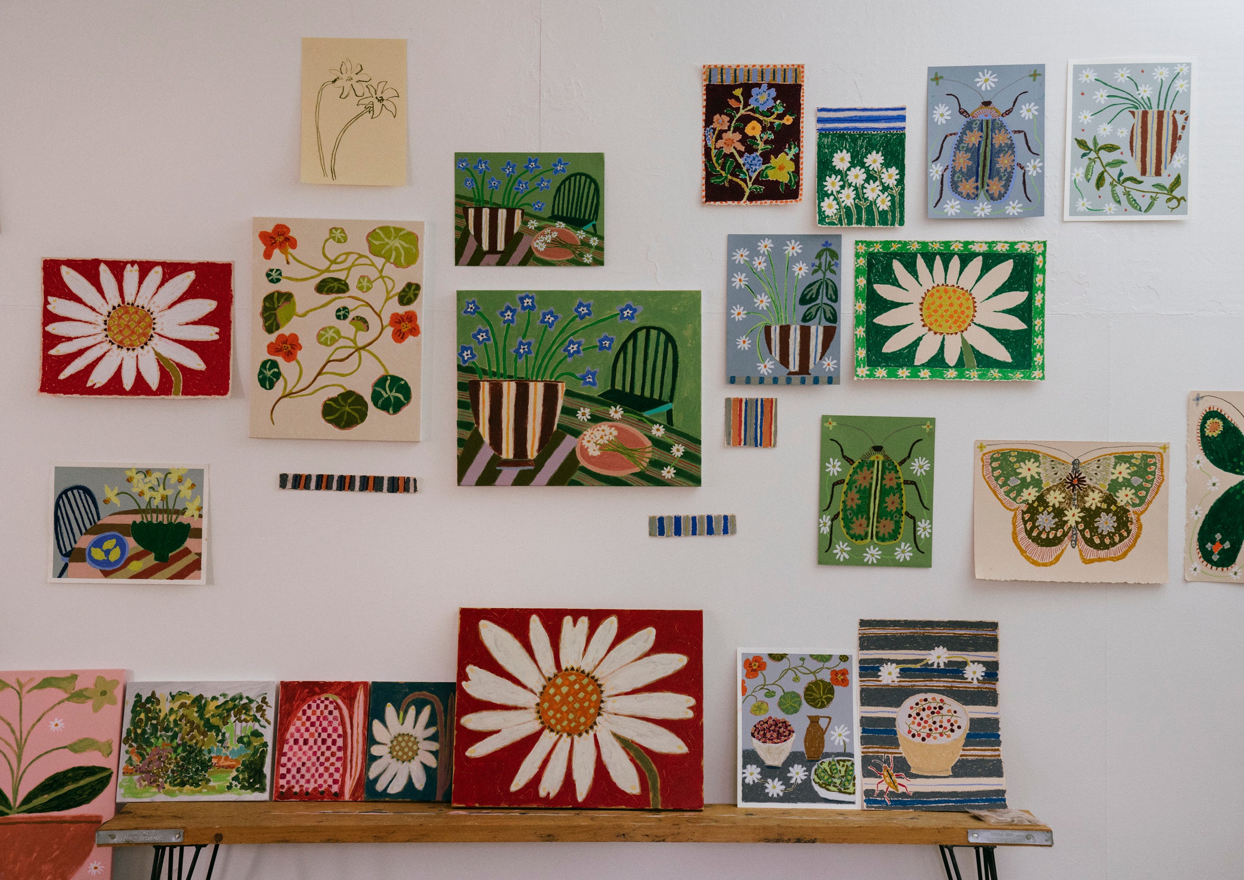 A gallery wall of nature-inspired paintings