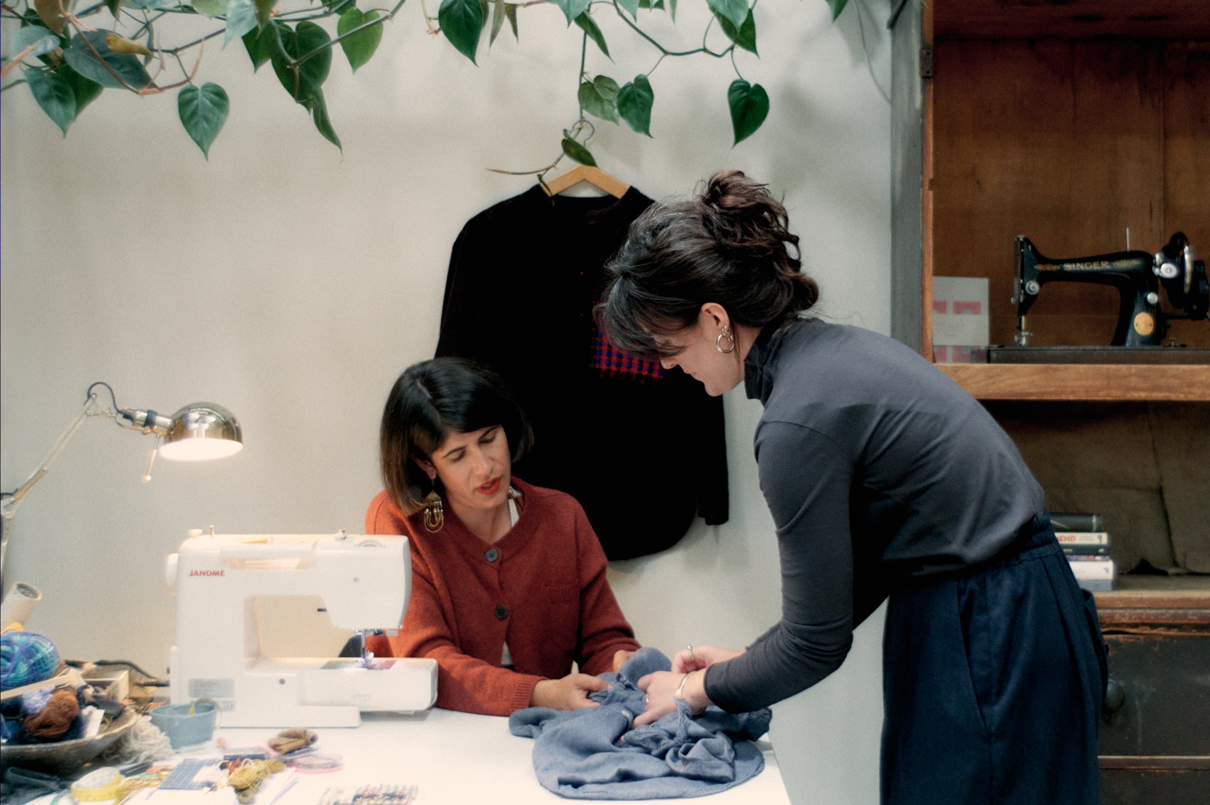 People mending clothes at the TOAST Circle Pop-Up
