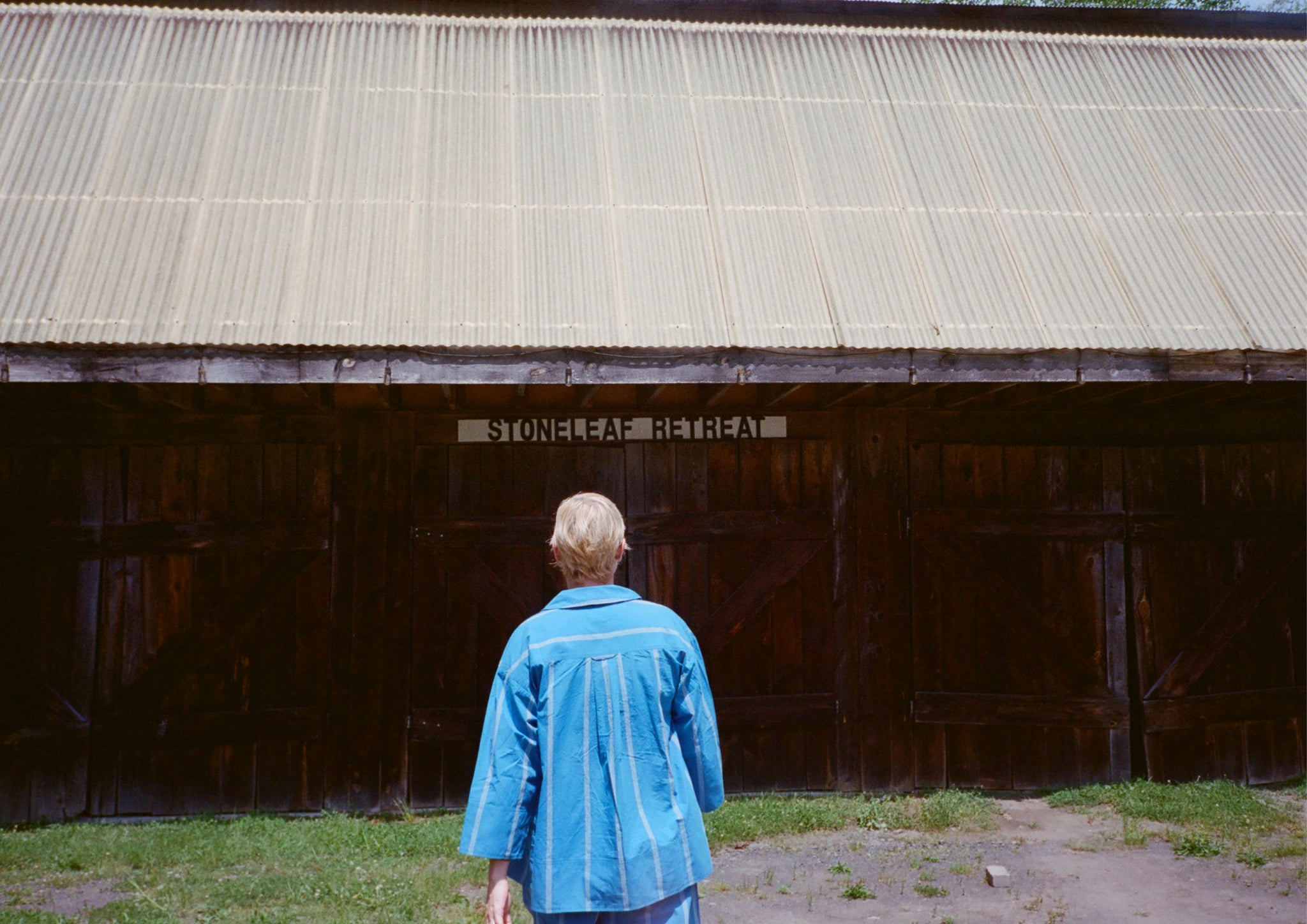 Woman walking towards a barn