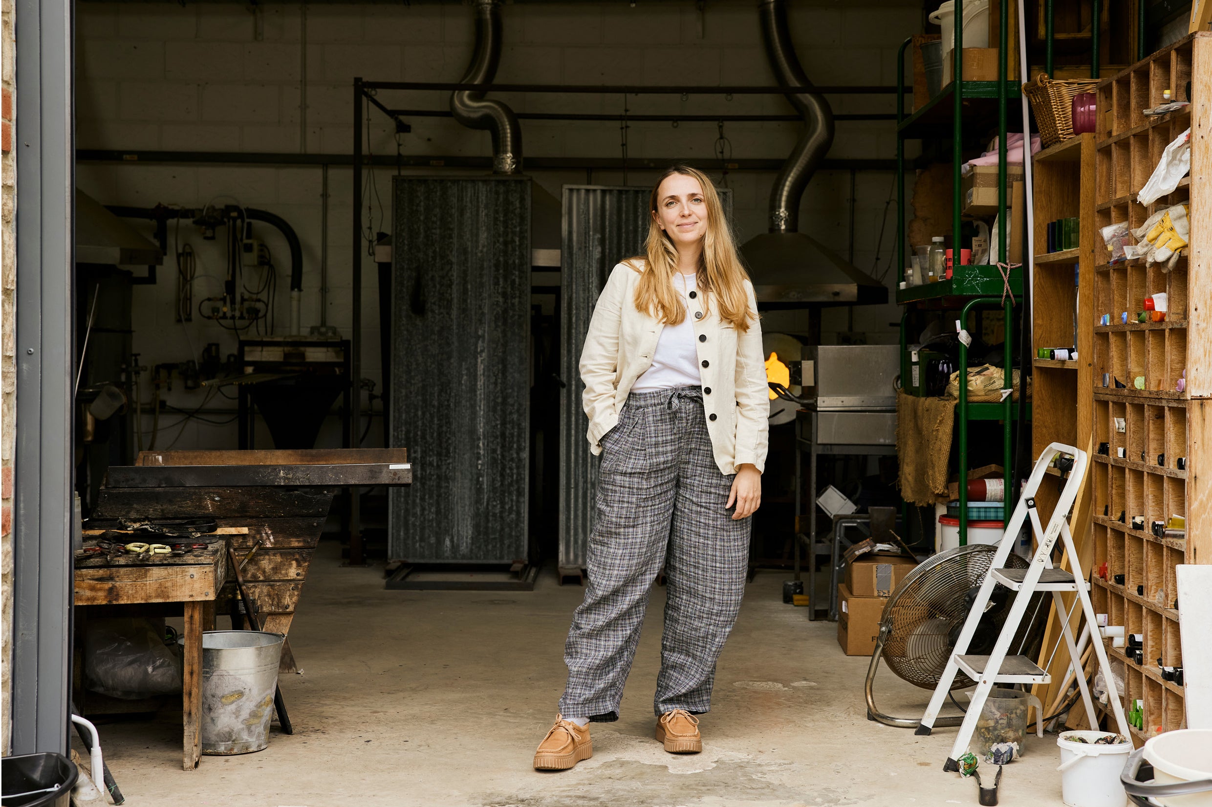 Artist Rosie Stonham stands in her workshop in Frome, Somerset