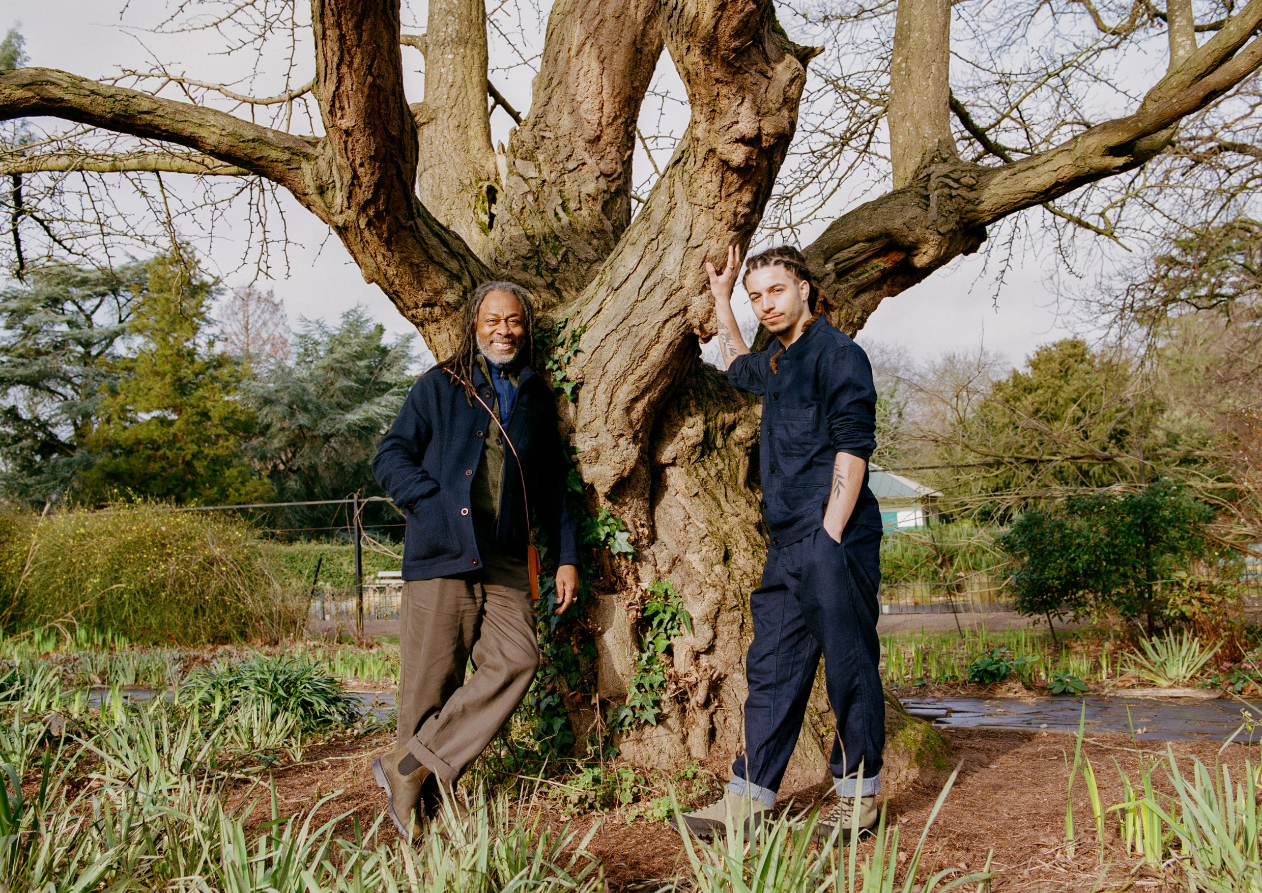 Two men stood in front of a tree