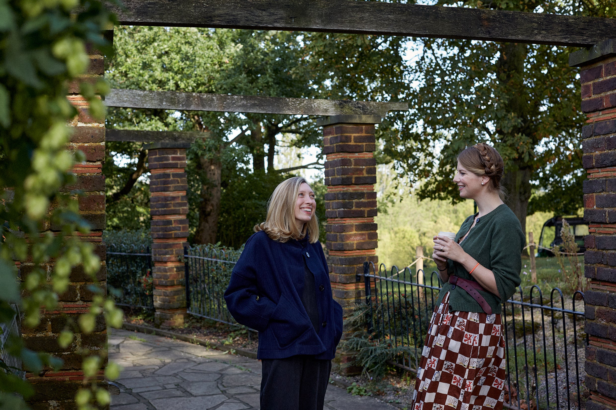 Women talking under a pergola